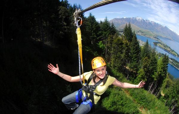   Ziptrek Ecotours guest zipping through the trees high above Queenstown.